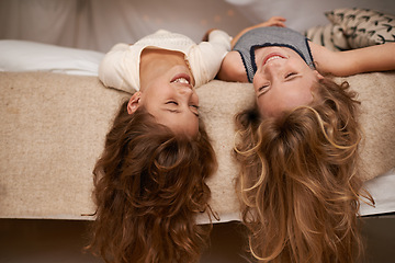 Image showing Happy, sleepover and playful children in bedroom for playing, bonding and relaxing in home. Laugh, friends and young girls upside down on bed for childhood, fun and happiness for youth relationship