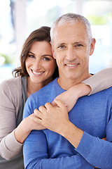 Image showing Couple, portrait and happy in home for hug with support, trust and romance in living room of house. Senior man, woman and smile with face for embrace, affection and healthy relationship in apartment