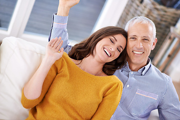 Image showing Couple, portrait and laughing in home for love with support, trust and comic joke in living room of house. Senior man, woman and funny on sofa with embrace, affection and relationship in apartment