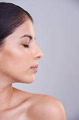 Image showing Woman, relax and profile with face in skincare, cosmetics or facial treatment on a gray studio background. Young female person, brunette or calm model in satisfaction for beauty or makeup on mockup