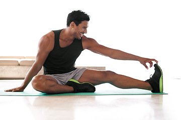 Image showing Man, leg and stretching on yoga mat or exercise flexibility with stiff muscles for athlete training, mobility or workout. Male person, foot and healthy performance or fitness strength, warm up or gym