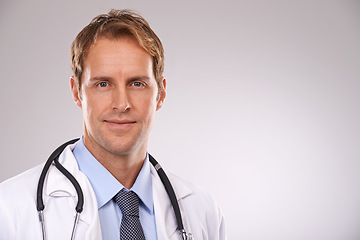 Image showing Man, doctor and physician in studio, portrait and medical professional on gray background. Male person, healthcare and pride for cardiologist career, nurse and trustworthy specialist for medicare