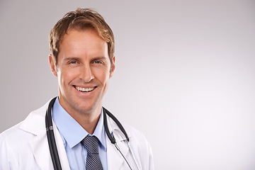 Image showing Man, doctor and smile in studio, portrait and medical professional on gray background. Male person, healthcare and pride for cardiologist career, physician and trustworthy specialist for medicare