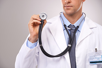 Image showing Stethoscope, doctor and hands of man in studio for medical research, consulting and wellness. Healthcare mockup, hospital and worker with equipment for cardiology, service and help on gray background