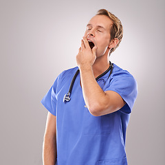 Image showing Doctor, studio and yawn for overworked, tired and burnout with stethoscope for job. Man, specialist and stress for professional, medic and health care or medical pressure isolated on white background