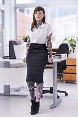 Image showing Tattoos, portrait and business woman in office with positive, good and confident attitude. Grunge, pride and professional edgy female creative designer with ink skin standing in modern workplace.