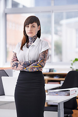 Image showing Tattoos, crossed arms and portrait of business woman in office with serious, pride and confident attitude. Grunge, professional and edgy creative designer with ink skin standing in modern workplace.