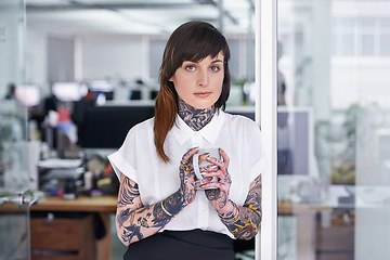 Image showing Tattoos, coffee and portrait of business woman in office with positive, good and confident. Grunge, cappuccino and professional edgy creative designer with ink skin standing in modern workplace.
