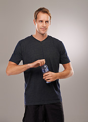 Image showing Thinking, studio or man drinking water for fitness, hydration or workout break isolated on grey background. Healthy person, training or thirsty athlete with h2o liquid drink for exercise or detox