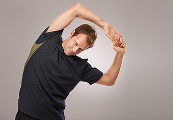 Image showing Man, fitness or workout of stretching, flexibility or training as exercise, self care or strength. Runner, athletic person or sportsman in muscle, mobility or warm-up in studio on grey background