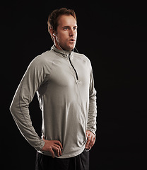 Image showing Earphones, thinking or runner in studio for fitness, running workout or exercise with radio music or podcast. Breathe, athlete and confident sports man ready to start training on black background