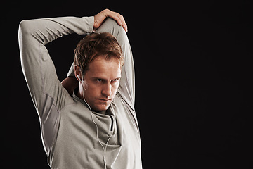 Image showing Man, arms and stretching workout in studio or exercise training with flexibility, mobility or black background. Male person, fitness and earphones or music playlist with health, performance or mockup