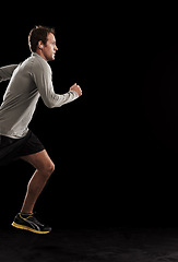 Image showing Man, cardio and running exercise in studio for athlete performance or marathon, training or black background. Male person, fitness and sports with mockup space for healthy, workout or competition