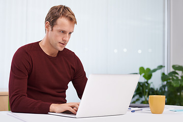 Image showing Businessman, laptop and online research in office with paperwork as graphic designer. entrepreneur or project planing. Male person, typing and desk for creative agency or career, email or internet