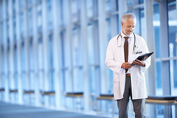 Image showing Checklist, happy doctor and man reading in hospital for healthcare, wellness and notes. Clipboard, medical professional and smile of mature surgeon with paper, results and report on chart in clinic