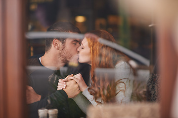 Image showing Couple, kissing and holding hands on date at cafe for bonding, romance and healthy relationship with relax. Man, woman and affection at coffee shop with lens flare, trust and love on anniversary trip