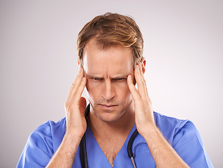 Image showing Doctor, studio and headache for stress, worry or tension and stethoscope for job. Man, worry or migraine for professional, medic and health care or medical pressure and overworked on white background