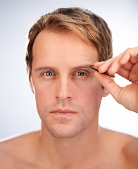 Image showing Man, portrait and tweezers for eyebrow for cosmetic hair removal for grooming, skincare or mockup space. Male person, face and tool in studio for wellness plucking, dermatology or white background