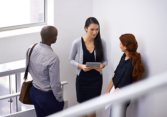 Image showing Colleagues, communication and teamwork in stairwell, talking and corporate employees. Talking, tablet and team or coworkers during break, technology and discussion and feedback on workplace stairs