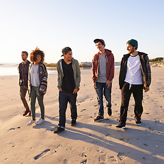 Image showing Sand, sunset and group of friends at beach for vacation adventure, support and bonding together in Miami. Nature, summer and people by ocean for holiday, travel or weekend trip for peace at seaside