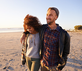 Image showing Love, travel and happy couple at beach with hug, support or bonding on sunset walk in nature. Happy, care and people embrace at the ocean for sunrise journey, adventure or romance in Hawaii together