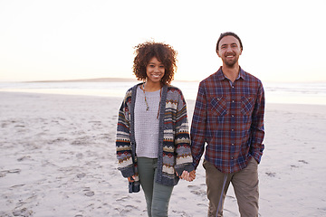 Image showing Couple, beach and walking together holding hands, happy calm people on vacation. Ocean, outdoor and partners in love with respect and care, date and romantic stroll for relax with seaside sunrise