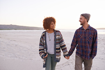 Image showing Couple, ocean and walking holding hands in nature, happy calm people on vacation. Sea, outdoor and partners in love with respect and care, date and romantic walk for relax with seaside sunrise