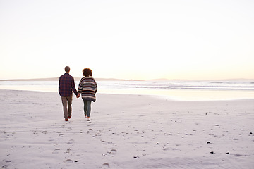 Image showing Couple, sea and walking together holding hands, happy calm people on vacation. Ocean, outdoor and partners in love with respect and care, date and romantic stroll for relax with seaside sunrise