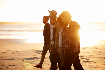 Image showing Sunset, beach or friends walking in nature for vacation, bonding or holiday outdoor together. Lens flare, journey or gen z group of people at sea for fresh air, sunshine or sunrise ocean adventure