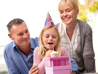Image showing Child, blow or candle for happy birthday, party or cake as fun wish, family or bonding together. Papa, mama or girl or smile at celebration, congratulations or childhood growth and development