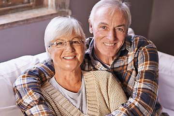 Image showing Senior couple, hug and portrait on sofa with smile, love and connection in living room for retirement. Elderly woman, old man and embrace on couch in lounge with pride, care and happy in apartment