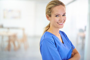 Image showing Nurse, arms crossed or portrait of a happy woman in hospital for medical, support or mockup space. Smile, healthcare and confident female surgeon nursing in clinic for wellness, medicine or treatment