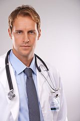 Image showing Man, doctor and professional in studio, portrait and medical expert on gray background. Male person, healthcare and pride for cardiologist career, serious face and trustworthy specialist for medicare