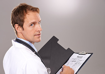 Image showing Clipboard, documents and portrait of doctor in studio for medical research, insurance and report for hospital. Healthcare, clinic and man with paperwork for consulting and planning on gray background