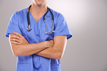 Image showing Man, nurse and arms crossed for healthcare in studio, confidence and physician on gray background. Male person, medical expert and pride for medicare, professional and support or help for diagnosis