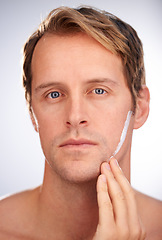 Image showing Man, portrait and skincare cream in studio for moisturiser routine for dermatology, transformation or cleaning. Male person, face and product for hygiene lotion or facial, white background or mockup