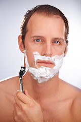 Image showing Man, portrait and shaving cream with razor for beard hair removal or grooming, maintenance or white background. Male person, face and smile with tool for dermatology hygiene, studio or mockup space