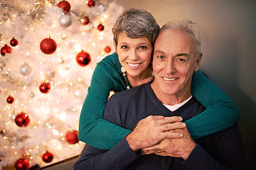 Image showing Christmas, portrait and senior couple hug with love, care and support together in a home on holiday. Tree, retirement and marriage with a smile and happy in a house with celebration and santa hat