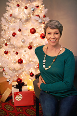 Image showing Christmas, tree and portrait of mature woman in home for holiday with presents on vacation. Happy, person and relax on with festive xmas decoration and gift box in living room and enjoy retirement