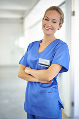 Image showing Happy woman, portrait and nurse with confidence in career ambition for healthcare or science at hospital. Young female person, scrub or medical doctor with smile or arms crossed for PHD at the clinic