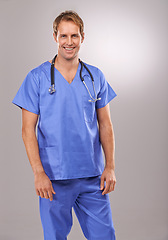 Image showing Man, nurse and portrait in studio, medical expert and specialist on gray background. Happy male person, cardiologist and proud of choice or decision on medicare, trustworthy physician and health