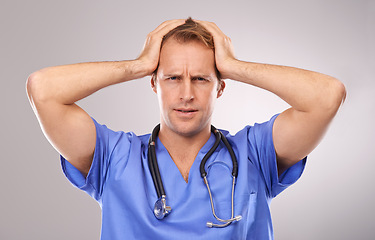 Image showing Doctor, studio and headache for migraine, worry or tension and stethoscope. Man, burnout or migraine for professional, medic and health care or medical pressure and overworked on white background