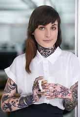 Image showing Tattoos, coffee and portrait of business woman in office with positive, pride and confident attitude. Grunge, smile and edgy female creative designer with ink skin standing in modern workplace.