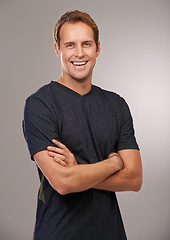 Image showing Studio, portrait or fitness with arms crossed, smile or trainer for running workout, exercise or health wellness. Grey background, sports athlete or happy man ready to start training with confidence