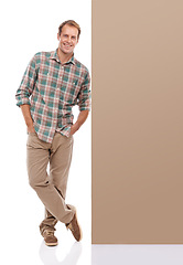 Image showing Studio, billboard and portrait of man with mockup for promotion, information and fashion. Male person, smile and relax by banner for happiness, presentation and confidence on white background