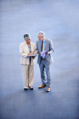 Image showing Professional, businesspeople talking and documents, signing for work with coworkers. Mature, business man and woman discussing information, lawyers for corporate company staff standing together