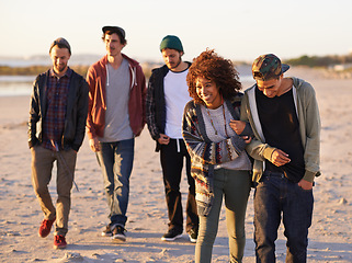 Image showing Summer, sunset and couple with friends at beach for support, adventure and vacation together in California. Nature, sand and people by ocean for holiday, travel or weekend trip with love at seaside