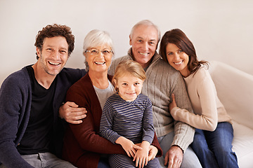 Image showing Grandparents, parents and child on sofa for portrait with hug, care or love with generations for bonding in home. Mother, father and senior people with kid for embrace on lounge couch in family house