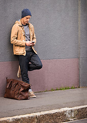 Image showing Man, waiting and travel with taxi from phone in city for morning transportation for vacation or holiday. Luggage, bag and person with journey to work or search smartphone online for cab to airport