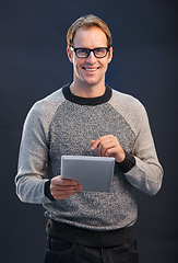 Image showing Man, glasses and tablet in studio with smile for portrait, connection or contact by dark background. Person, entrepreneur or geek with digital touchscreen, pride or fashion with app for social media